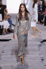 Spring 2018 Michael Kors Runway Look 72 Silver Sequin Dress on Nude Stretch Net w Asymmetrical Hem