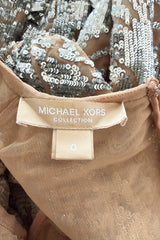 Spring 2018 Michael Kors Runway Look 72 Silver Sequin Dress on Nude Stretch Net w Asymmetrical Hem