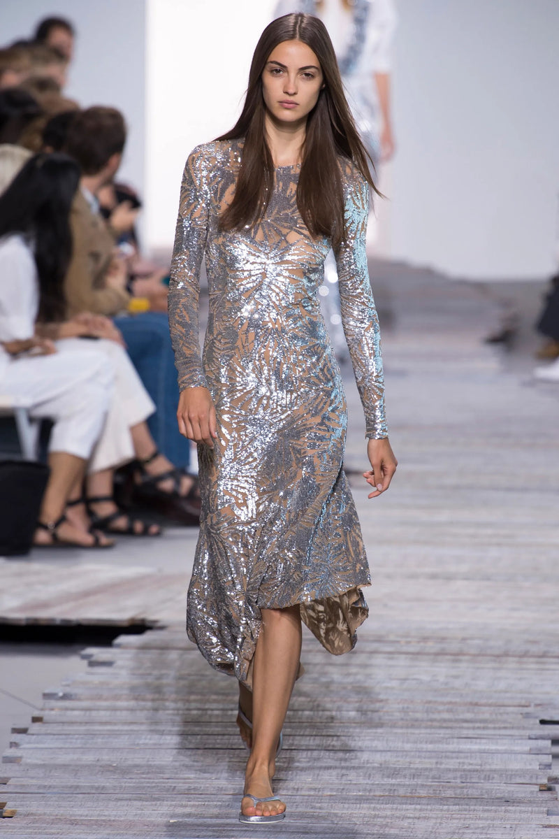 Spring 2018 Michael Kors Runway Look 72 Silver Sequin Dress on Nude Stretch Net w Asymmetrical Hem