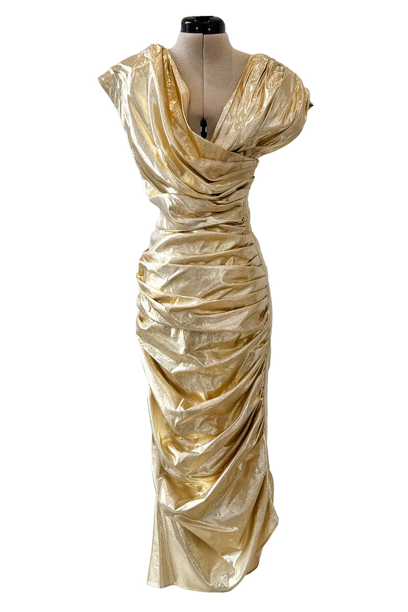gold lame dress Liquid lam is draped with a plunging V neckline and a fluid cape back in this mesmerizing dress, designed to reveal its full impact in motion Gold pleated lame dress is sheer luxury Formal Dresses Metallic Lame Dress