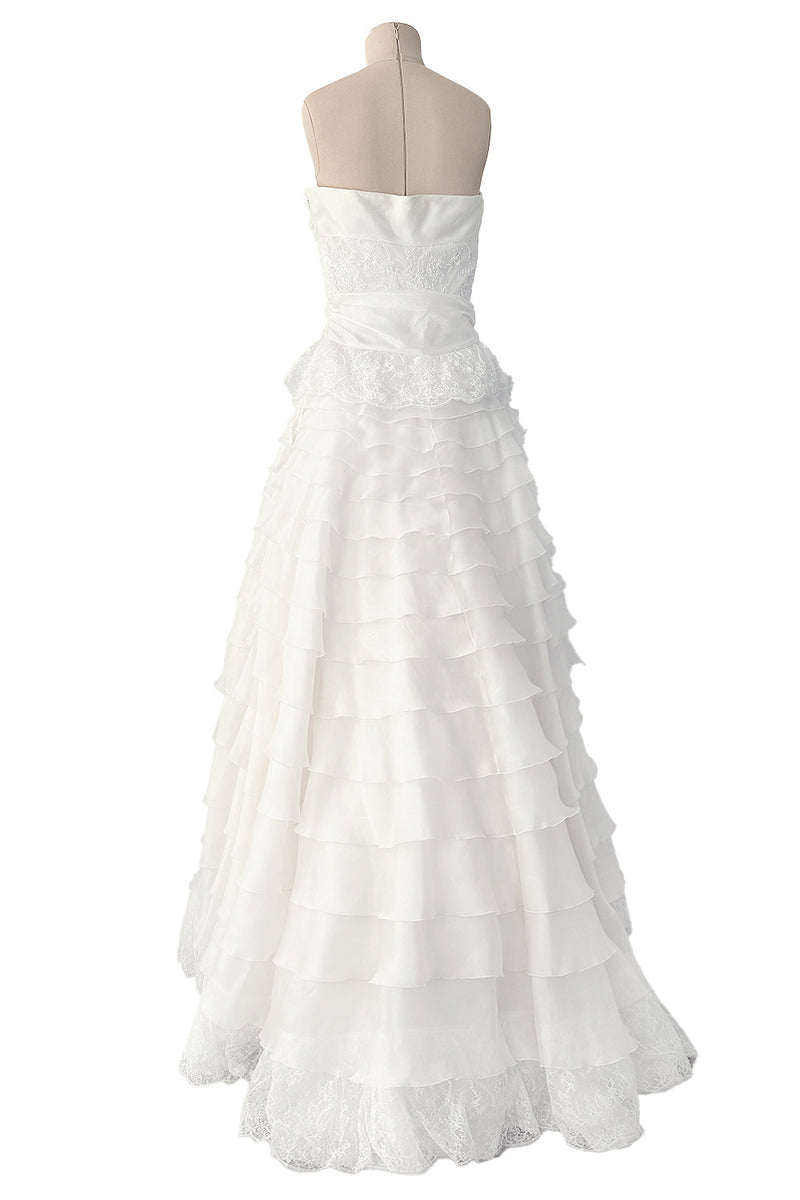 ivory satin ruffle strapless dress Tulle Midi Van Atelier this dress offers a flattering silhouette complemented by a statement tiered ruffle skirt that adds movement and elegance Ivory Strapless Designer Satin Pockets